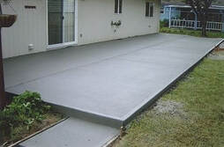 concrete patio installed behind house